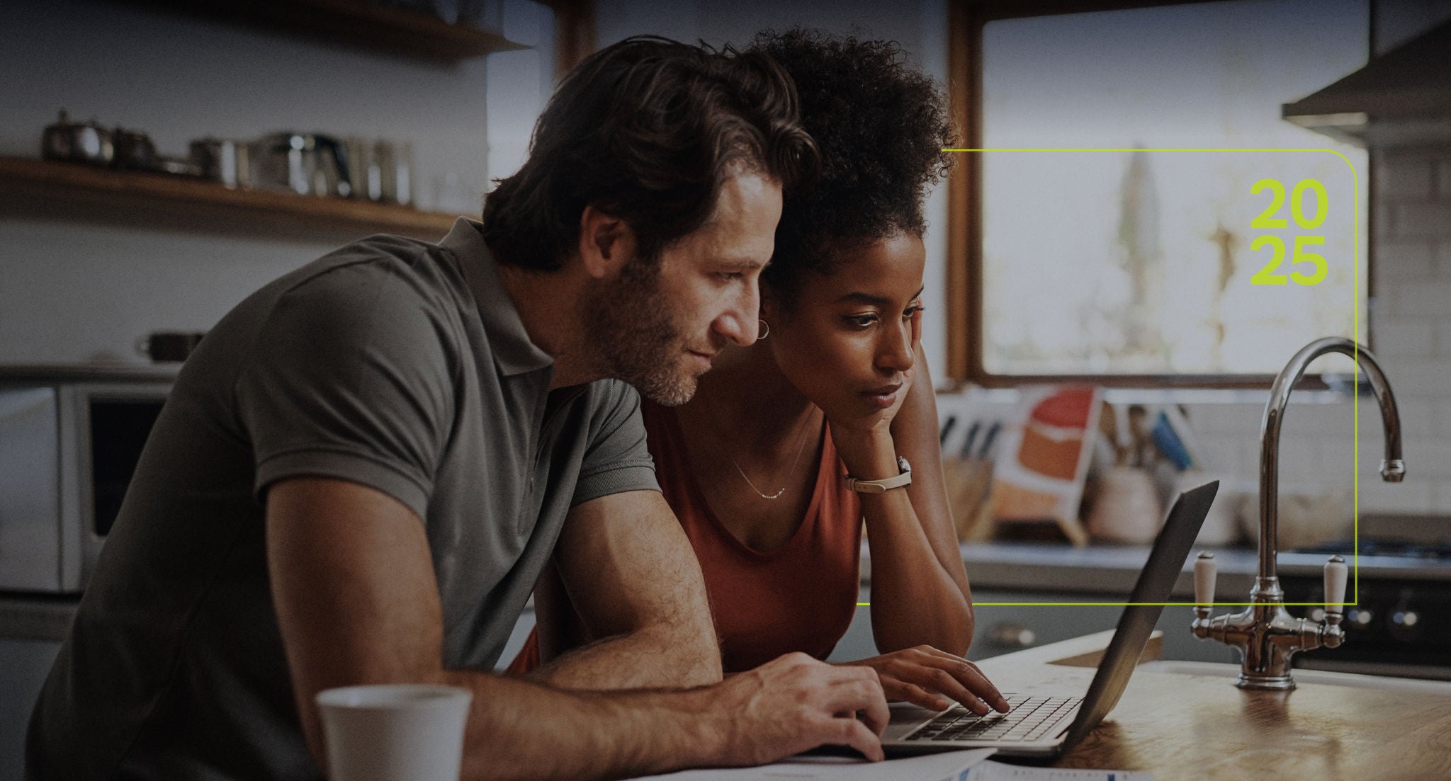 Couple looking at a laptop in their kitchen