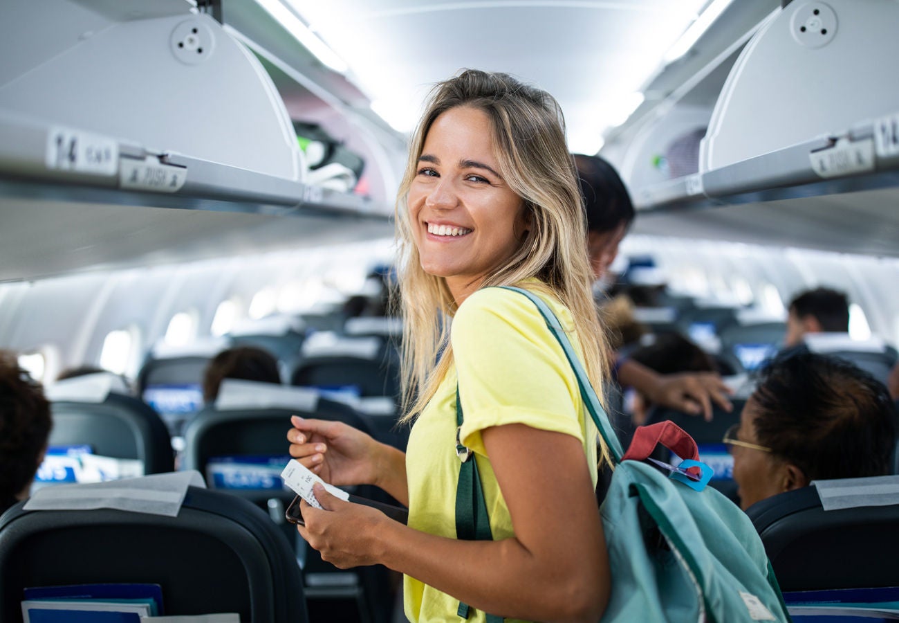 A happy passenger finds their seat for the journey ahead.