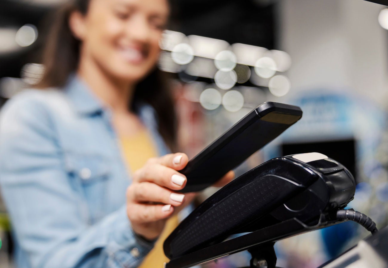 Woman paying at a store with her phone