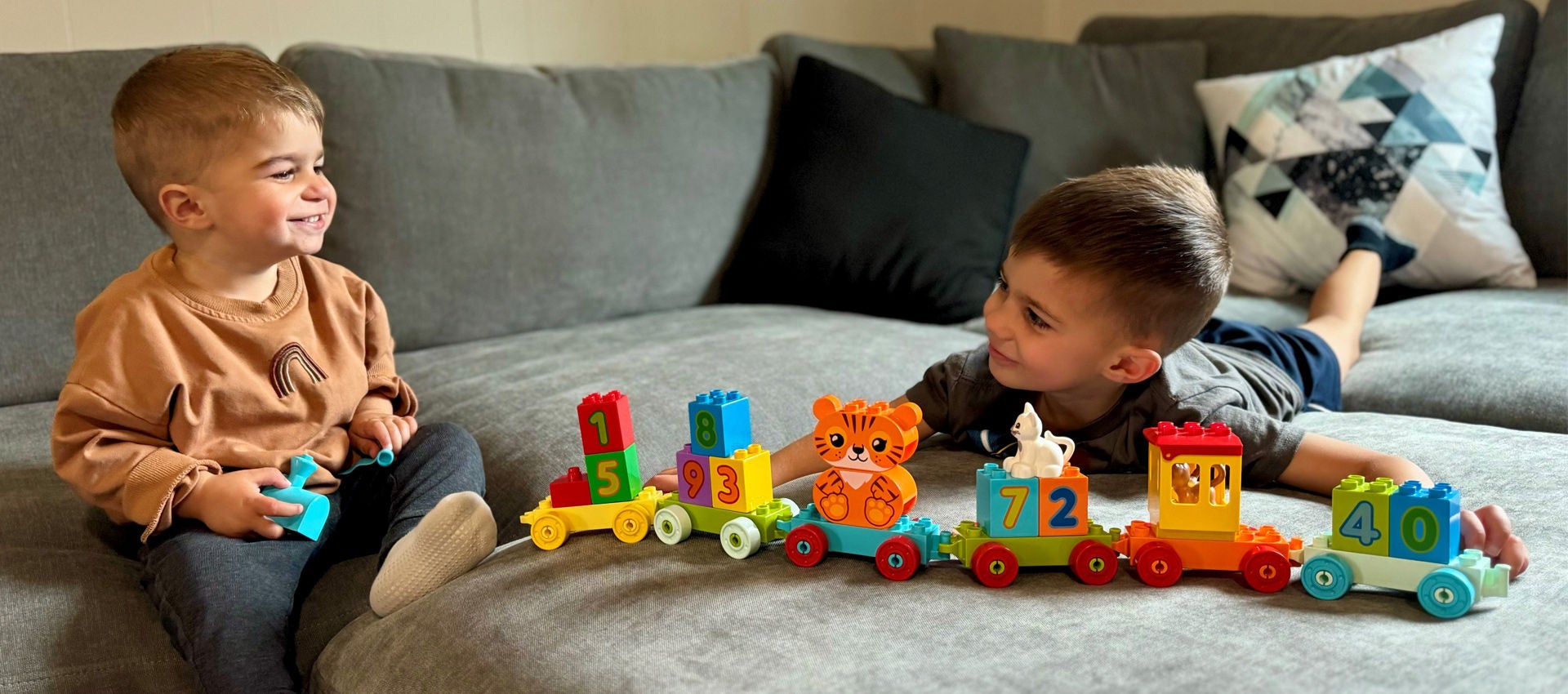 Two children play together with LEGO DUPLO.