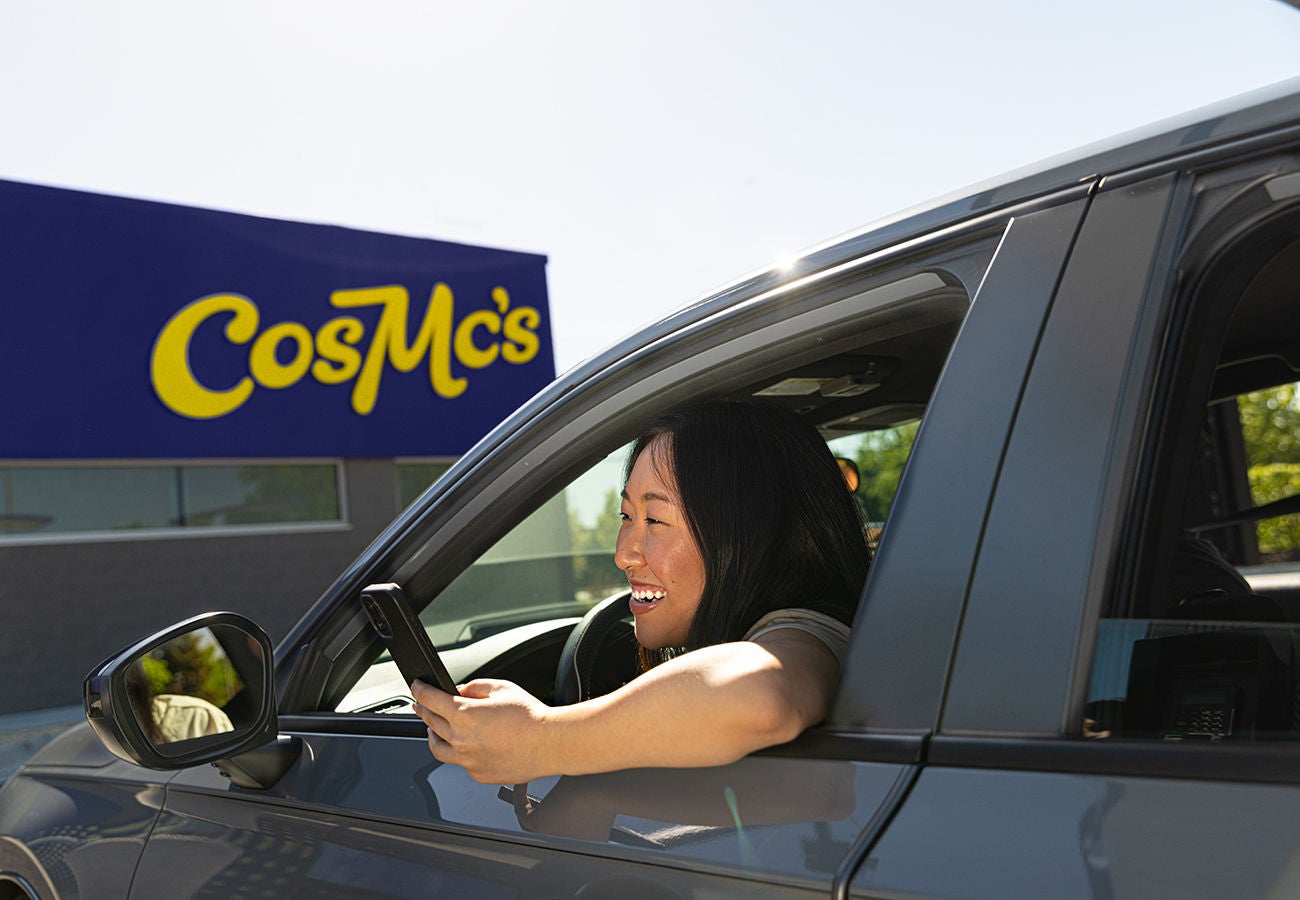 Young woman is submitting order in front of store