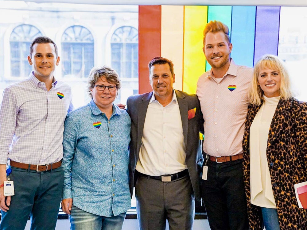 A groupf of Slalom employees at an office Pride event.