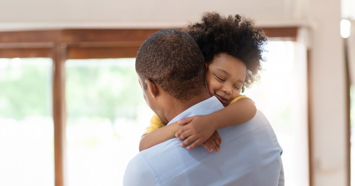 A father and child hug. 