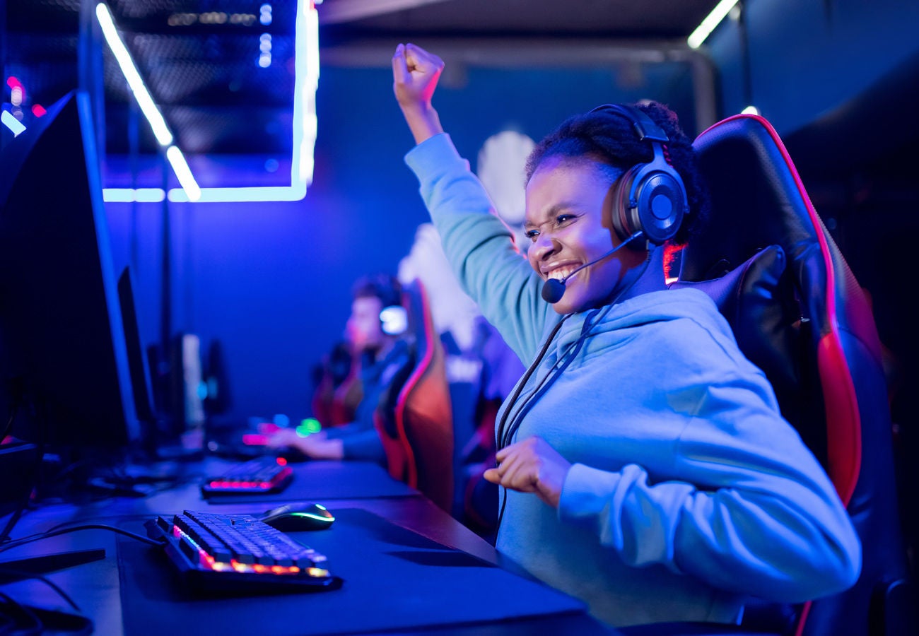 A female gamer celebrates a victory.