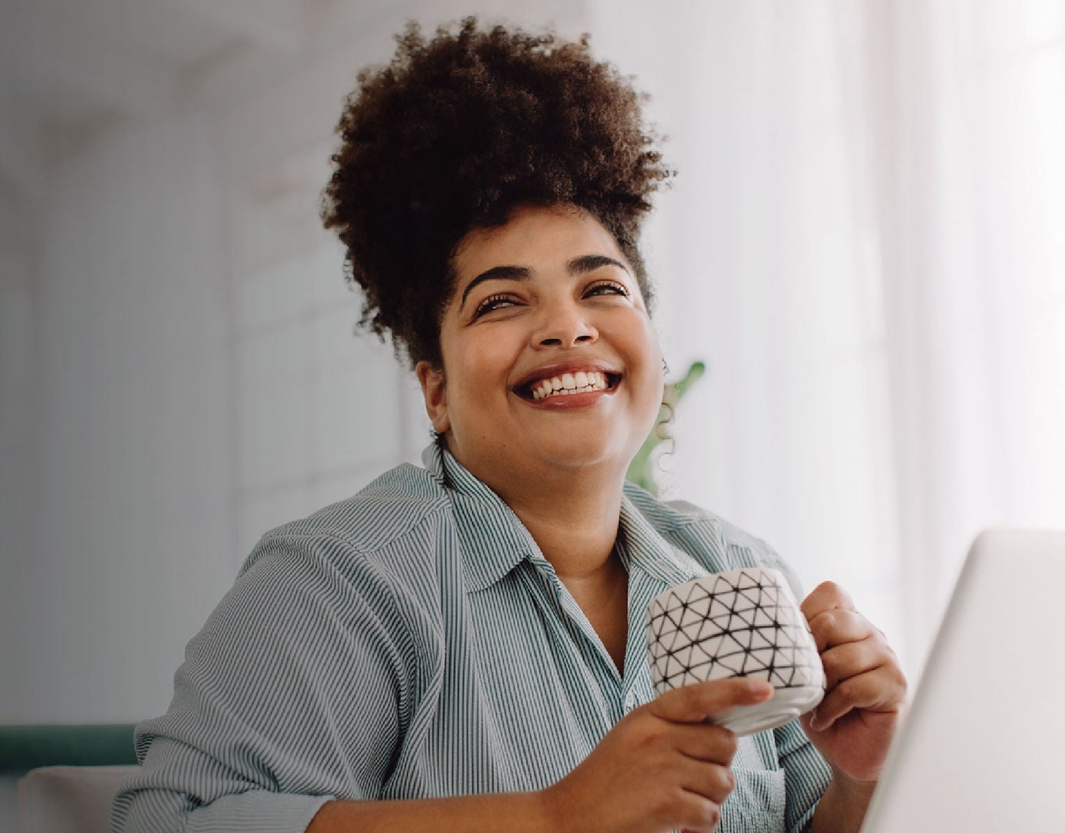 woman with mug smiling