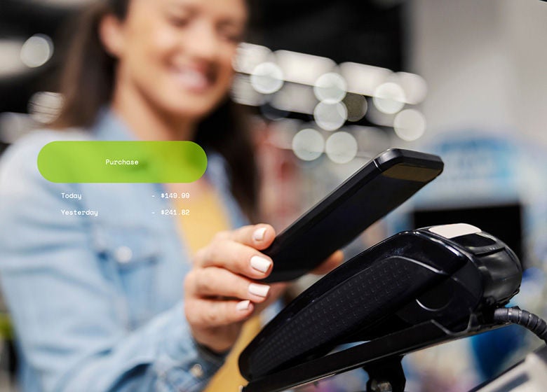 Woman paying at a store with her phone