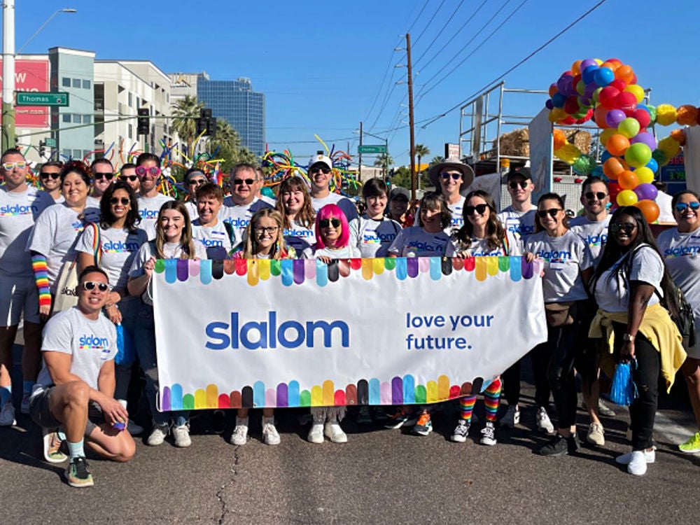 Slalom employees and friends and family celebrate Pride together at a parade.