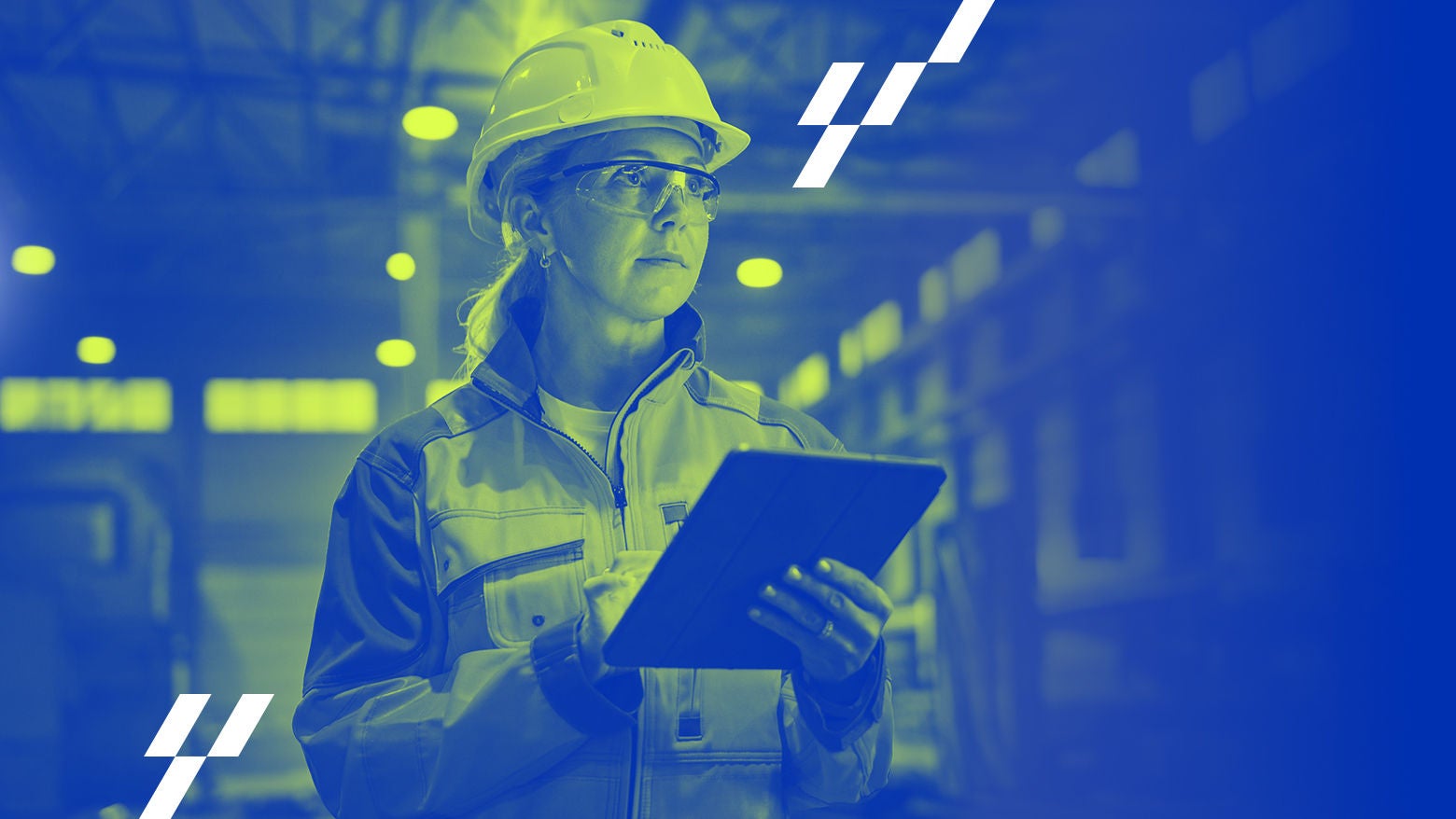 Professional Heavy Industry Engineer/Worker Wearing Safety Uniform and Hard Hat Uses Tablet Computer. Serious Successful Female Industrial Specialist Walking in a Metal Manufacture Warehouse.